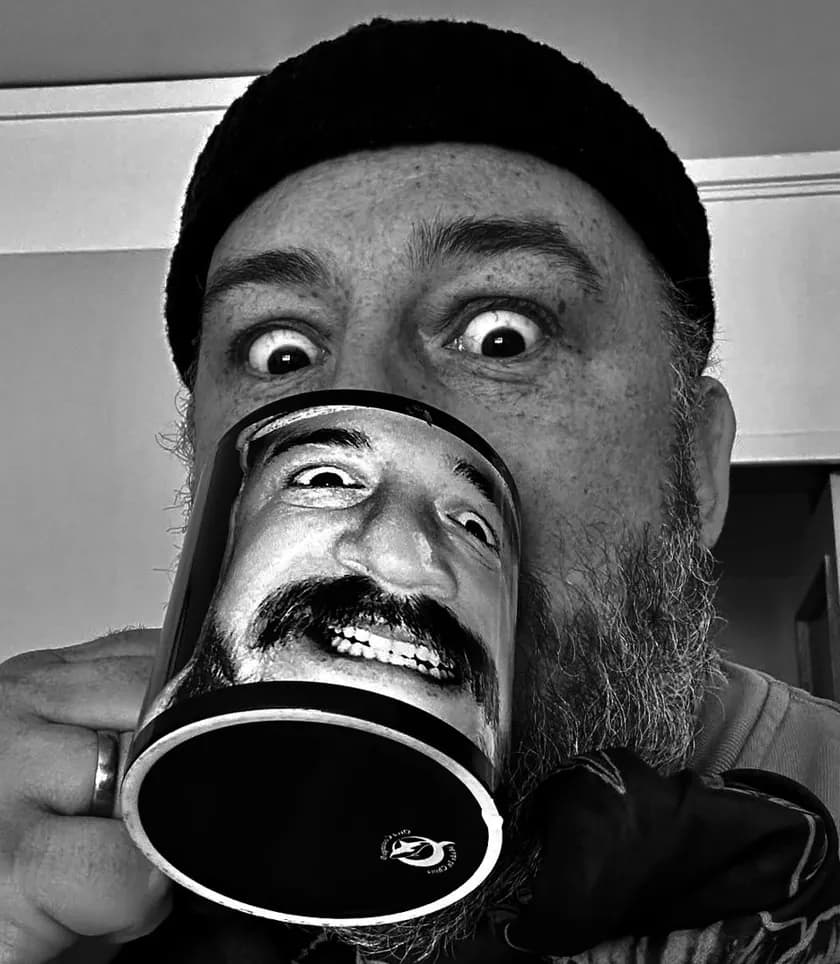 Andreas Zalbo drinking coffee from a mug printed with his own face